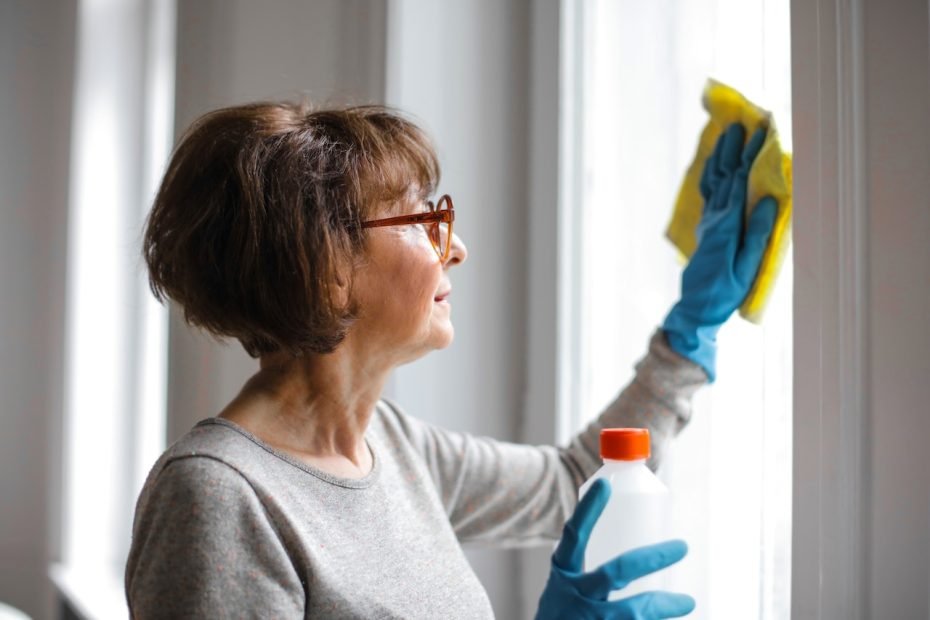 Grandma cleaning windows.