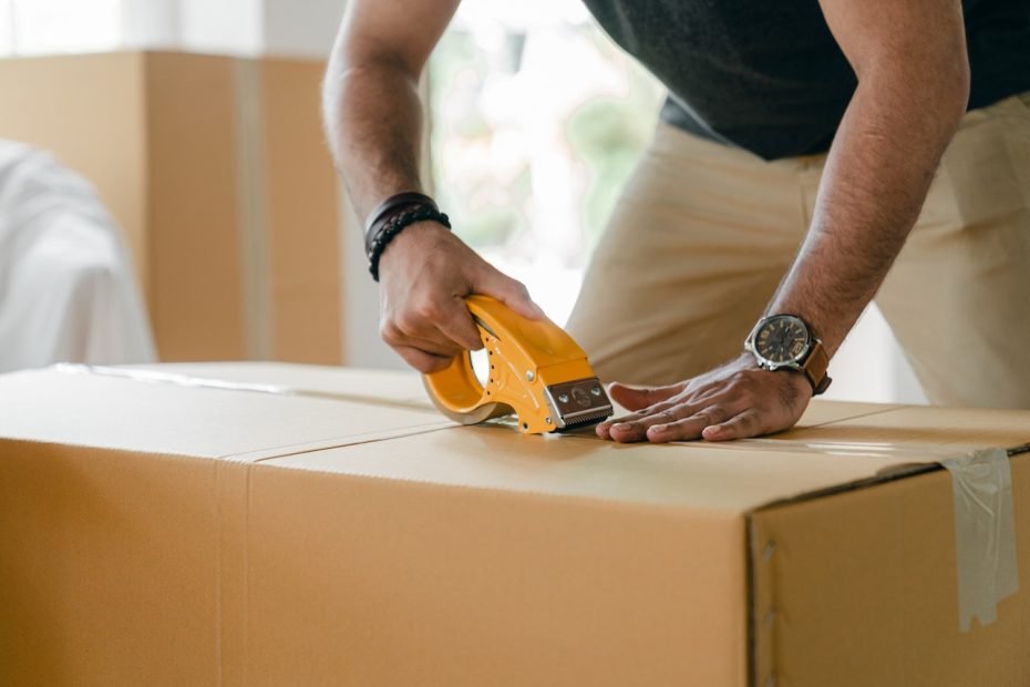 A man labeling boxes.