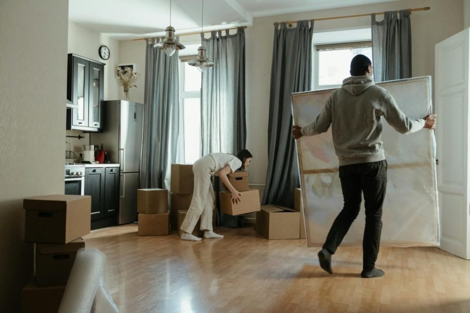 A couple unpacking boxes and settling into their new home