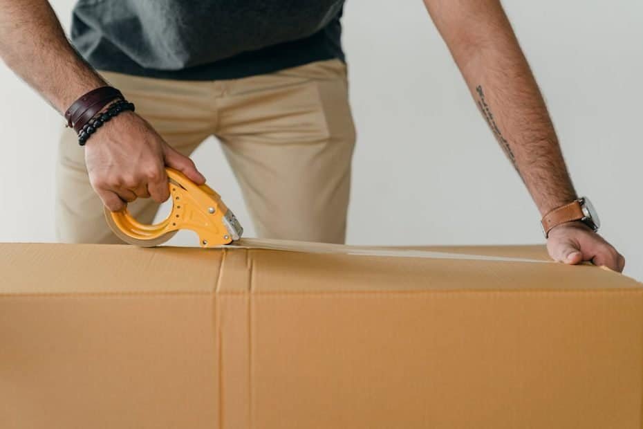 A man taping a cardboard box