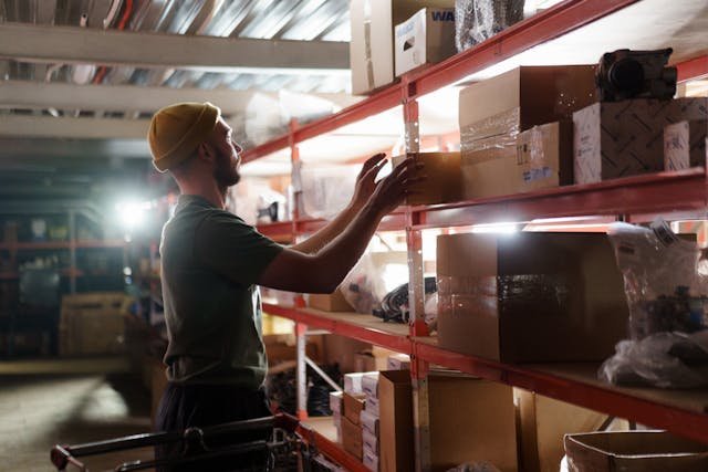 a man pulling box from shelf