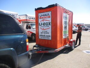 U-Haul U-Box moving container loaded on a U-Haul trailer hitched to an SUV for self pickup